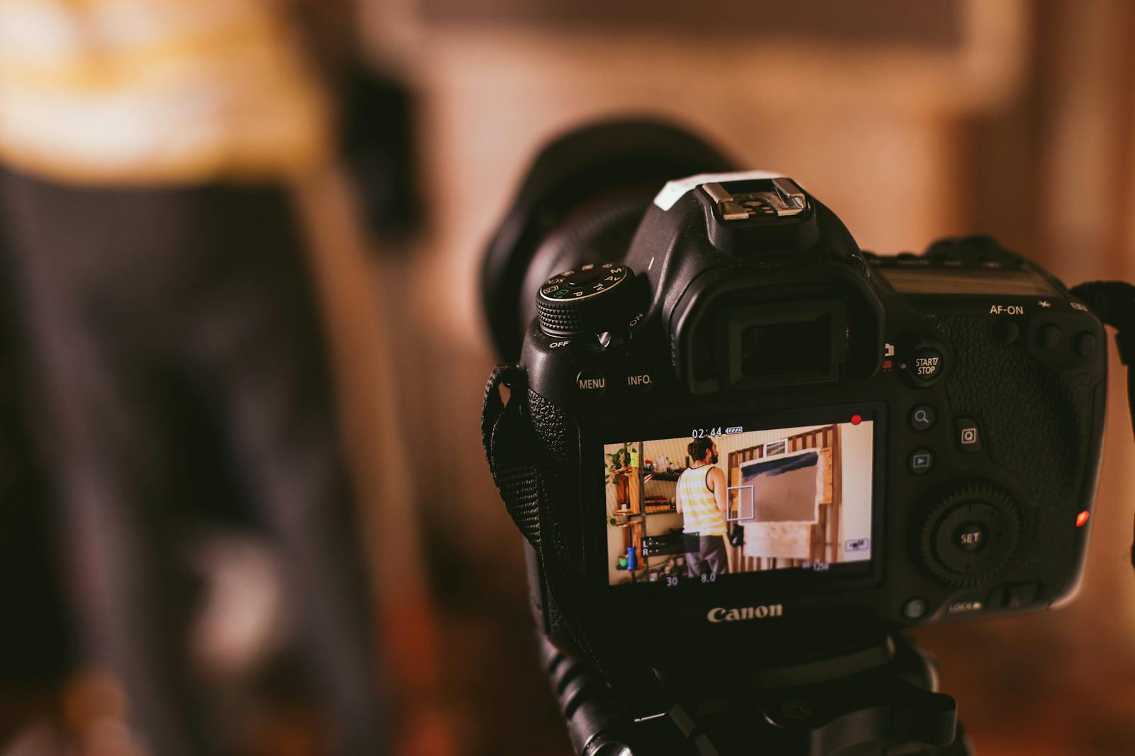 Selective Focus Photography of Woman Holding Dslr Camera